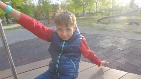 Boy rides a carousel and shows like Stock Footage 115098493