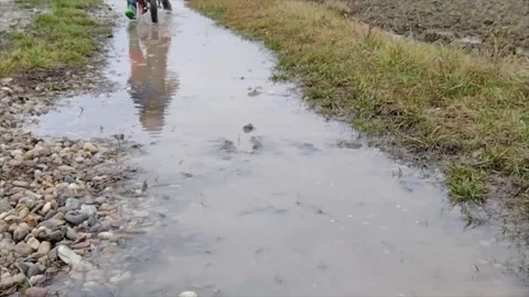 A boy rides his bike through the water - slow motion frame Stock Footage 166106954