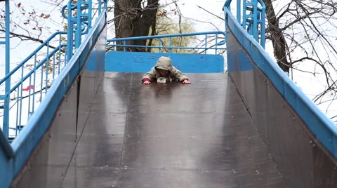 Boy rides on a sliding board Stock Footage 68449488