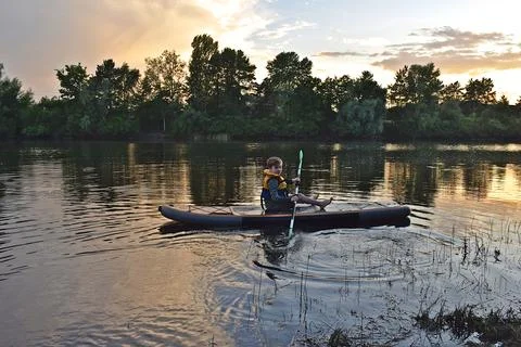 A boy rides a SUP Фото