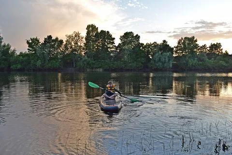 A boy rides a SUP Stock Photos