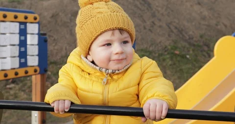 Boy rides a swing on a playground Video stock 119947425