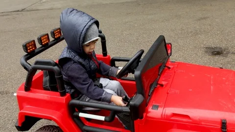 Boy rides on toy car 動画素材 106982811