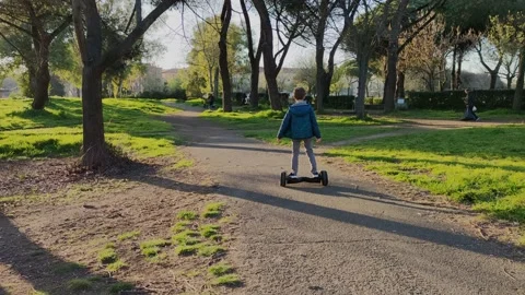 The boy rides a two-wheeled scooter Stock Footage 153242573