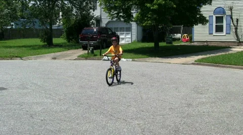 Boy riding by on bicycle 2 Stock Footage 500868
