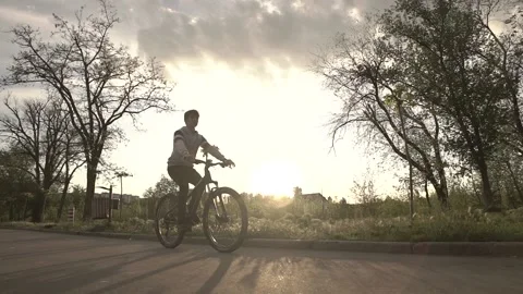 Boy riding the bicycle in the park Stock Footage 130472942