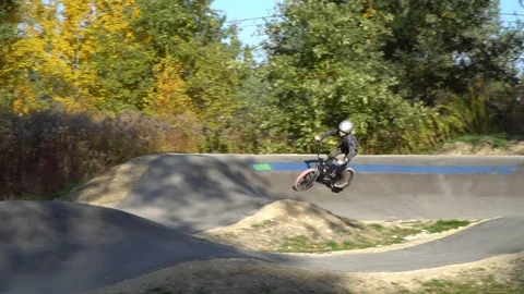 Boy riding a bicycle on a pumptrack Stock Footage 118890929