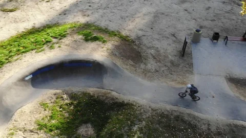 Boy riding a bicycle on a pumptrack Stock Footage 118890970