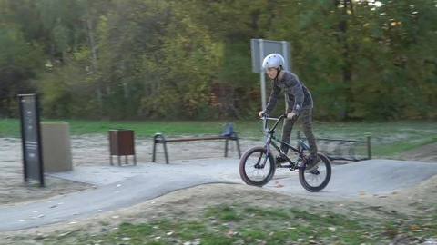 Boy riding a bicycle on a pumptrack Stock Footage 118891267
