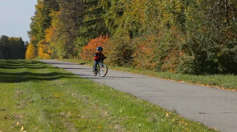 Boy riding a bicycle on the road Stock Footage 42236869