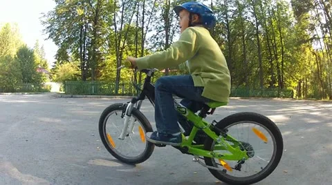 Boy riding on a bike Stock Footage 12364511