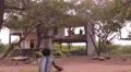 Boy riding a bike near a house in India HD Footage