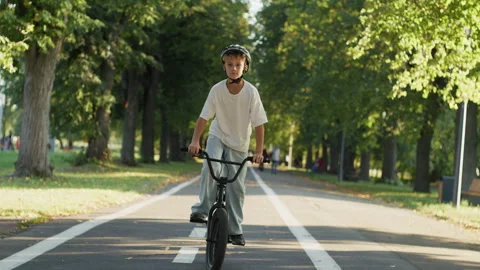 Boy Riding BMX Bicycle on Park Path Video stock 346147319