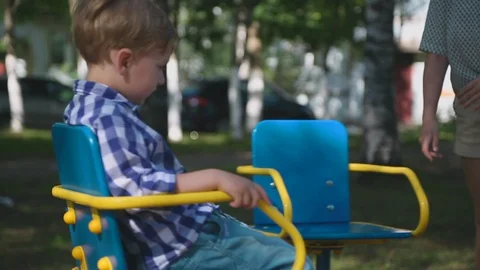 Boy is riding a carousel Video stock 92455349