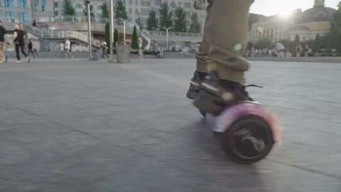 Boy riding on gyroboard or hoverboard  in a city Stock Footage 162368644