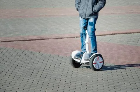 Boy riding a hoverboard in the square Stock Photos