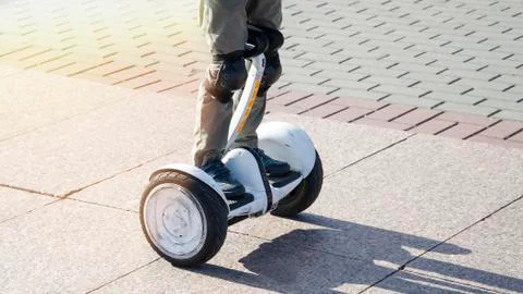 Boy riding a hoverboard in the square Stock Photos
