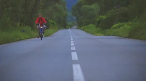 Boy Riding Motor Scooter On Road Stock Footage 63393737