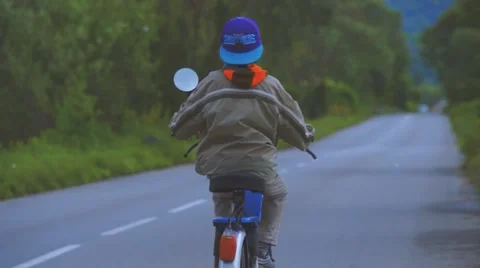 Boy Riding Motor Scooter On Road Stock Footage 63394522