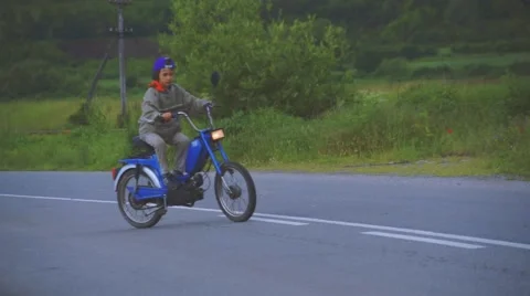 Boy Riding Motor Scooter On Road Stock Footage 63396698