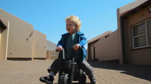 Boy riding plastic bike Video stock 53087857