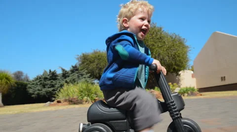 Boy riding plastic bike Video stock 53087977