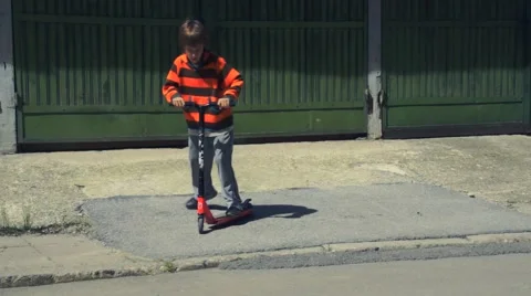 Boy riding scooter Stock Footage 63402541