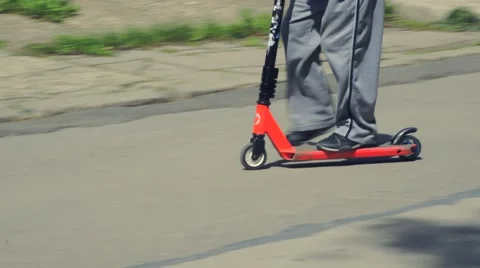 Boy riding scooter Stock Footage 63403586