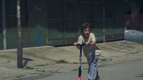 Boy riding scooter Stock Footage 63403753