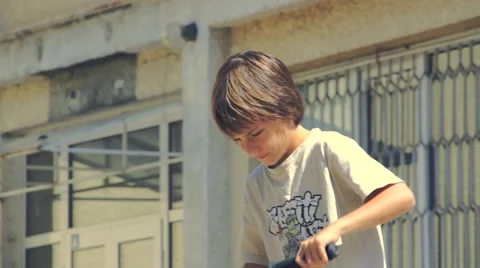 Boy riding scooter Stock Footage 63405493