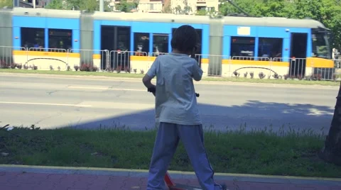 Boy riding scooter Stock Footage 63425036