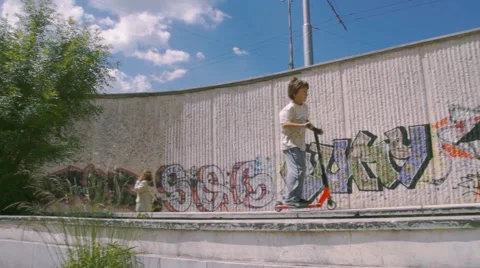 Boy riding scooter Stock Footage 63426129