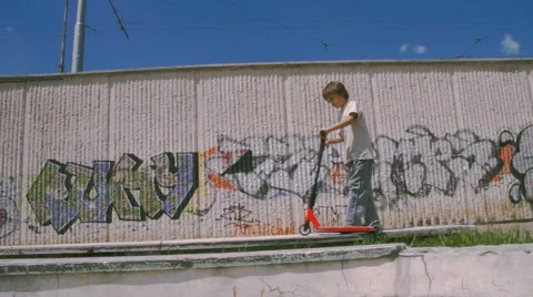 Boy riding scooter Stock Footage 63426229