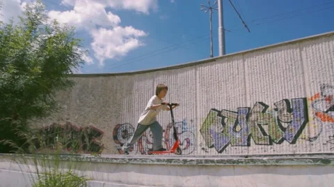 Boy riding scooter Stock Footage 63426304
