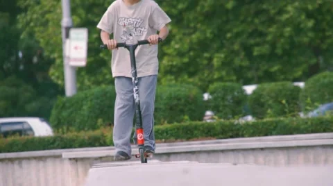 Boy riding scooter Stock Footage 63427771
