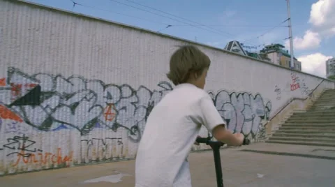 Boy riding scooter Stock Footage 63428056