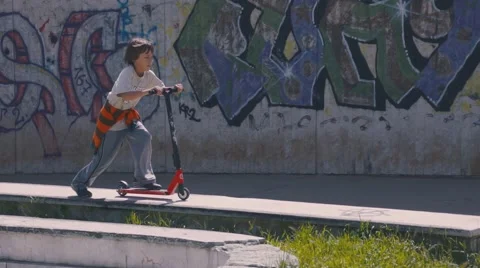 Boy riding scooter Stock Footage 63431307