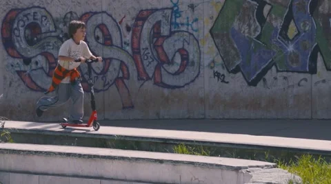 Boy riding scooter Stock Footage 63431345