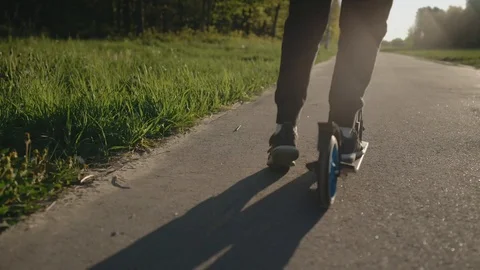 Boy riding a scooter Video stock 106945716