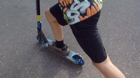 Boy riding a scooter Stock Footage 249905612