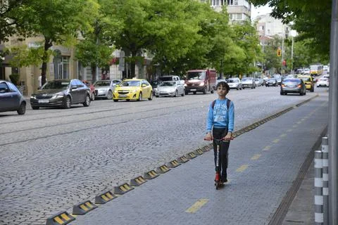 A boy riding a scooter in Sofia Stock Photos