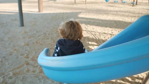 The boy is riding a slide on the playground Stock-Footage 76010612