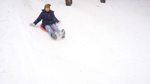 Boy riding a snow hill. Winter fun. Slow motion Stock Footage 100718800