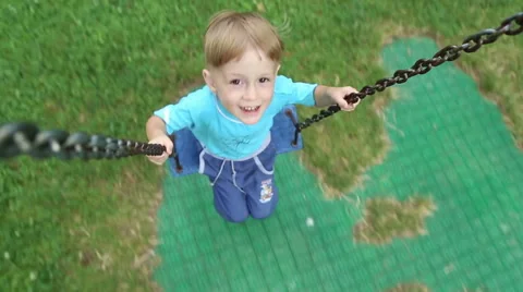 Boy riding on a swing Stock Footage 52431925