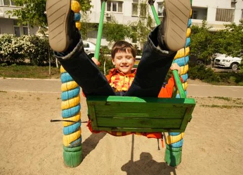 Boy riding on a swing Stock Photos