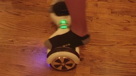 Boy riding a two wheel electric self balancing scooter 動画素材 57326647