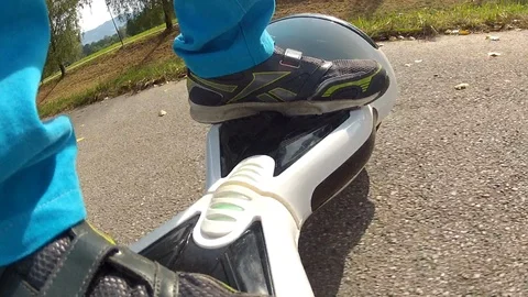 Boy riding on a white hoverboard, on a small road in the countryside Stock Footage 103671678