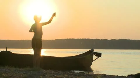Boy on the river sunset Stock Footage 10855574