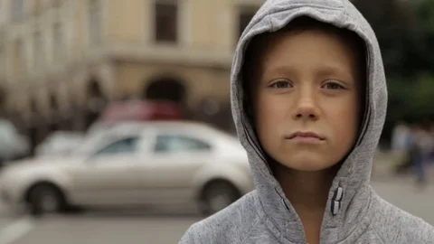 A boy on the road against a background of blurry cars in motion Stock Footage 79887235