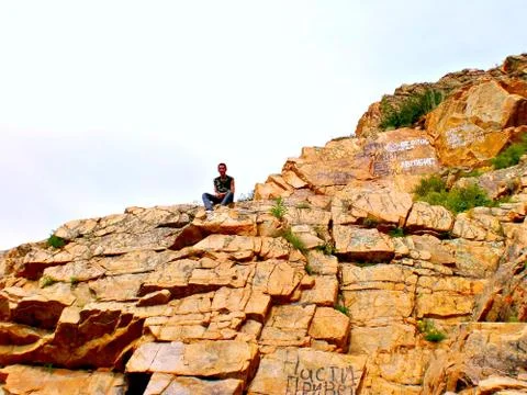 Boy on the rocks Stock Photos
